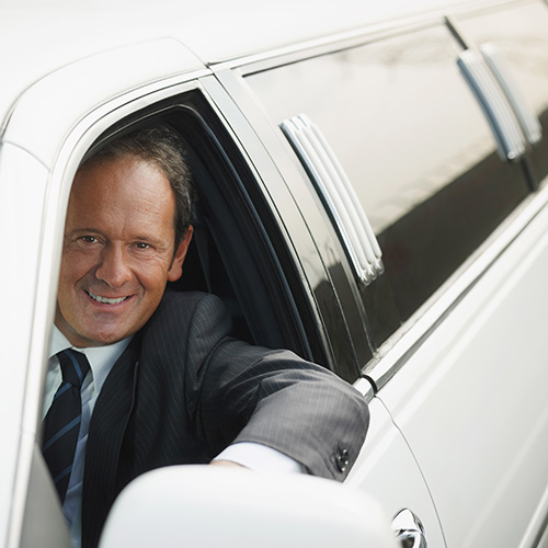 A happy chauffer smiles while providing New Jersey limo service.