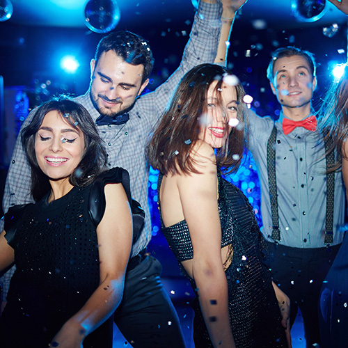 Teens dance at their prom having been dropped off by prom limo service.