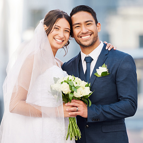 A happy couple smiles during their wedding limo service.